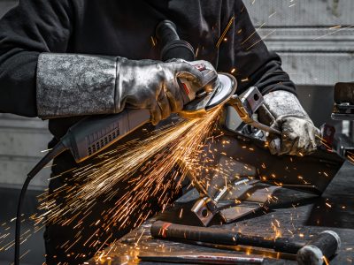 View of worker grinding a piece of metal, France